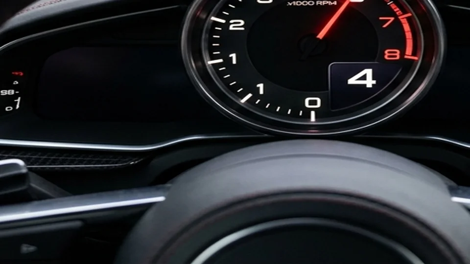 High-contrast instrument gauge cluster displaying tachometer revs and digital gear readout